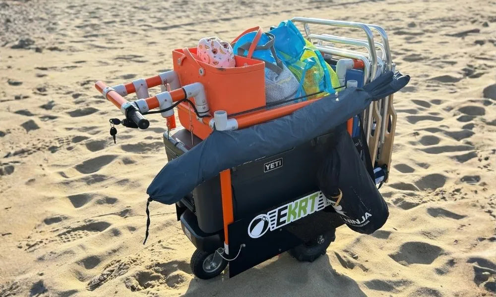 A beach e;ectric e-KRT on sandy shore, filled with cleaning bags and accessories. 