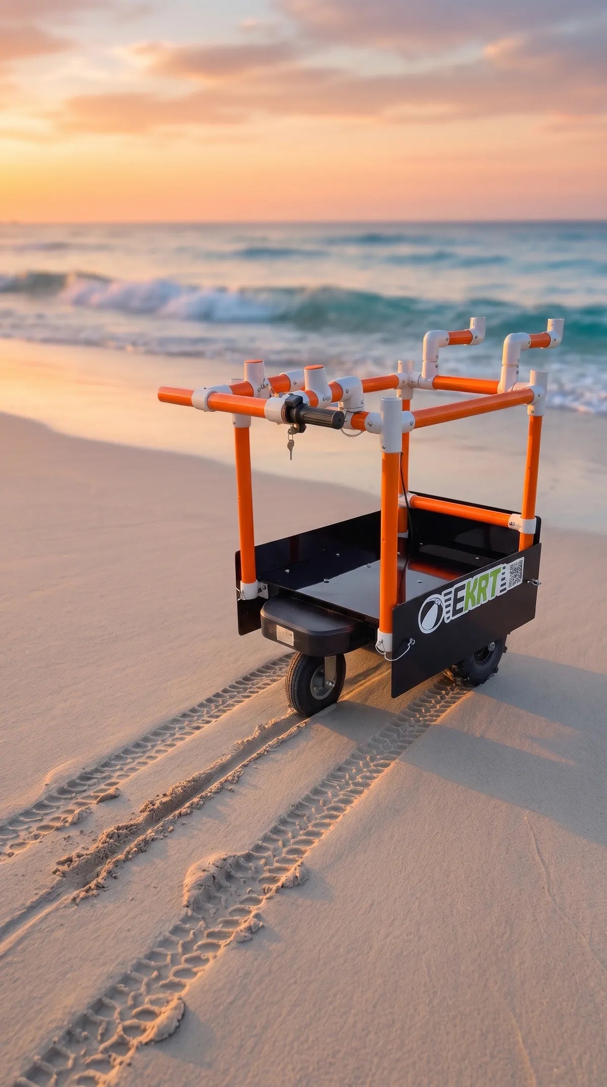 An electric beach cart with orange and black frame, positioned on a sandy beach with ocean waves and a sunset in the background.