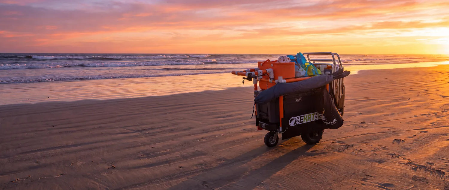 e-KRT electric beach cart loaded with beach gear at sunset beneath a HOW IT WORKS banner