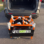 Folded e-KRT electric beach cart being loaded into the back of an SUV